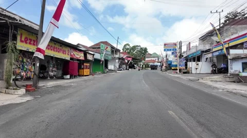 Empty road stretches through quiet village Stock Footage 345143645