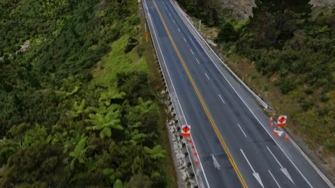 Empty road surrounded by green hills, New Zealand Stock Footage 88605624