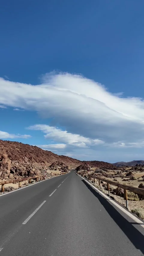 Empty road through volcanic desert landscape under dramatic clouds Stock-Footage 340336920