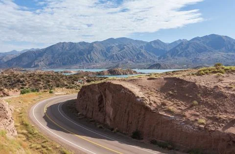 An empty road towards  the Andes mountain range in Argentina. Stock Photos