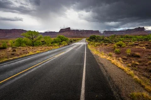 Empty Road towards the Needles District Canyonlands Utah Stock Photos