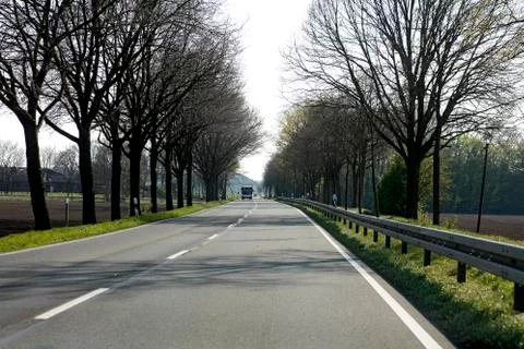 Empty road with trees Driving from Olfen to Dorsten road tripp backgrounds wa Stock Photos