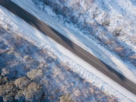 Empty road in winter with snow covered trees aerial view 写真素材