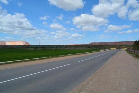 Empty road. Working machinery of the enterprise Stock Photos