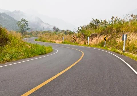 Empty road with yellow markings and foggy sky, travel Stock Photos