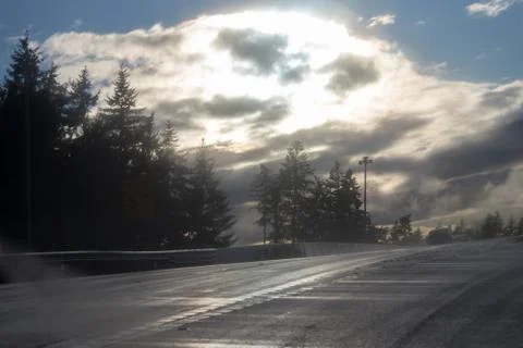 Empty roadway under clearing storm clouds Stock Photos