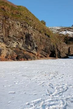 Empty rocky beach cliffs on a cold winters day Stock Photos