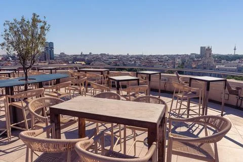 Empty rooftop tables and chairs with panoramic views across central Madrid .. 写真素材