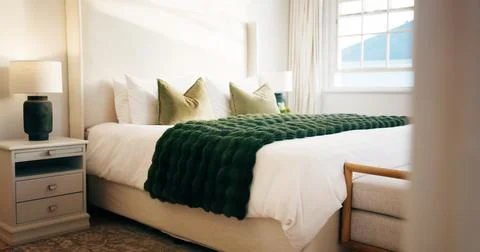 Empty, room and bed in hotel, hospitality and furniture with decor, real es.. Stock Photos