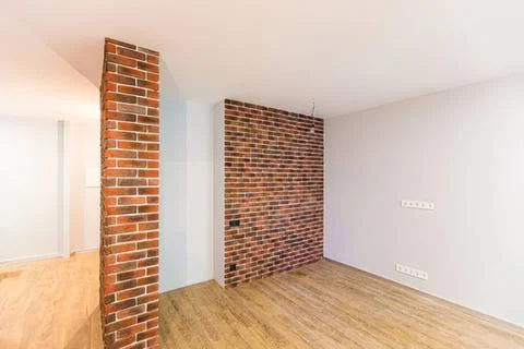 Empty room with brick wall and wooden floor in a house Stock Photos