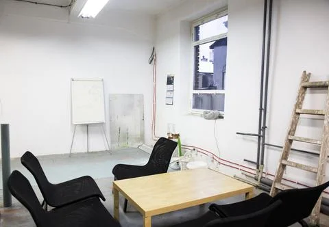 Empty room with chairs around table Stock Photos