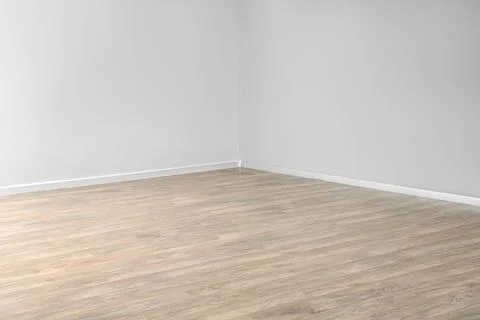 Empty room corner with light wood laminate flooring and white walls, minimali Stock Photos