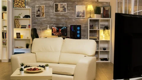Empty room with couch in the middle and gaming computer Stock Footage 121791197