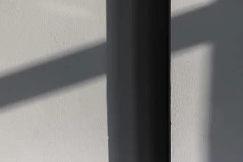 Empty room interior fragment with shadows pattern on gray wall Stock Photos