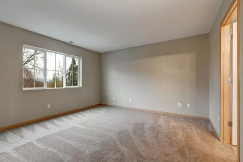 Empty room interior in grey tones with carpet flooring . Northwest, USA Stock Photos
