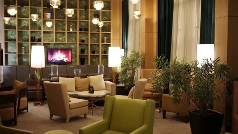 Empty room with sofa, armchairs, tv, flowerbed in hotel Mariott Stock Footage 83109753