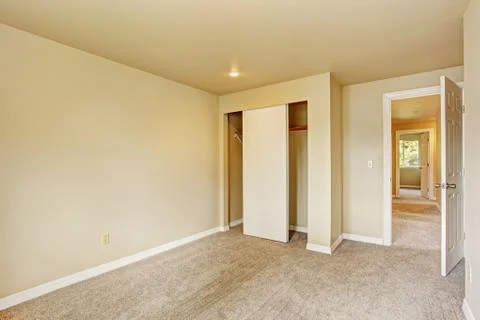 Empty room in soft ivory tones with closet Stock Photos
