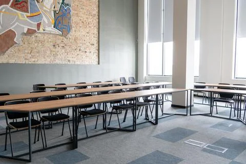 Empty room with tables and chairs for studying. University or school auditorium Stock Photos