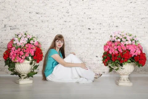 Empty room with white brick wall and beautiful flowers in pots Stock Photos