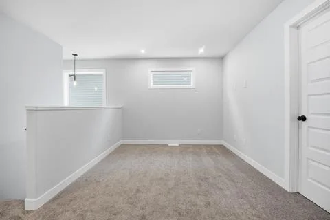 Empty room with white walls and carpeted floor Stock Photos