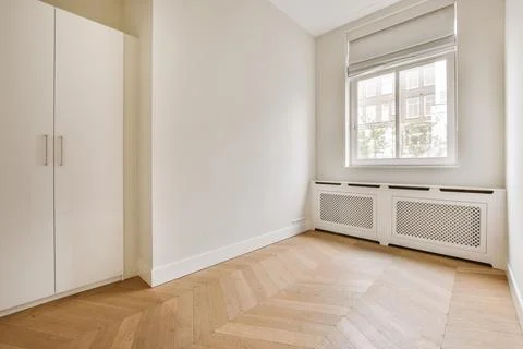 Empty room with window and radiator Stock Photos
