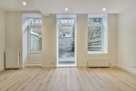 Empty room with window and radiator Stock Photos