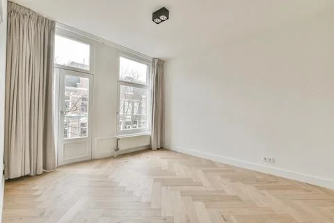 Empty room with window and radiator Stock Photos