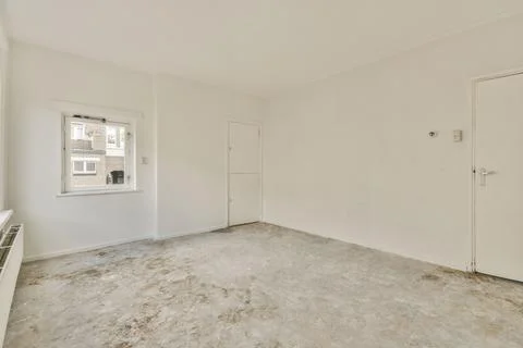 Empty room with window and radiator Stock Photos