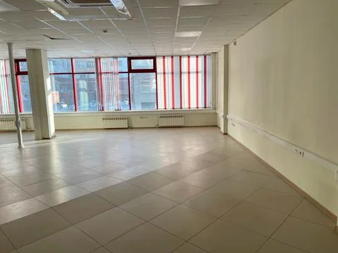 An empty room with a window. Preparing for renovation, rental property. Stock Photos