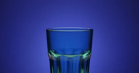 Empty rotating green glass isolated on purple colorful background. Blank empty Stock Footage 146170536