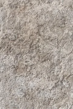 Empty rough, uneven texture of a gray concrete wall close up with copy space. Stock Photos