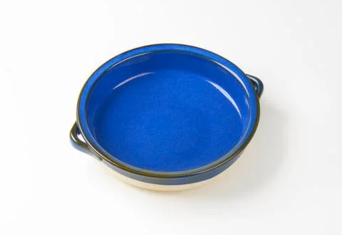 Empty round ceramic baking dish with two handles Stock Photos