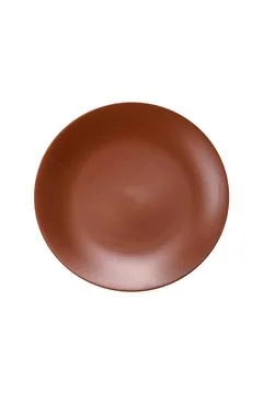 An empty round ceramic plate on a dark, textured brown background. An empty r Stock Photos