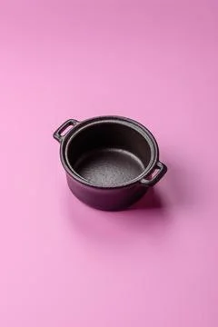 An empty round ceramic plate on a pink background as a kitchen utensil. An .. Stock Photos
