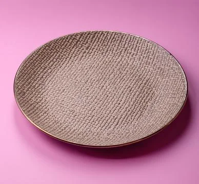 An empty round ceramic plate on a pink background as a kitchen utensil. An .. Stock Photos