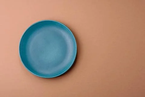 An empty round ceramic plate on a table, kitchenware. An empty plate Stock Photos