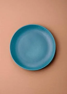 An empty round ceramic plate on a table, kitchenware. An empty plate Stock Photos