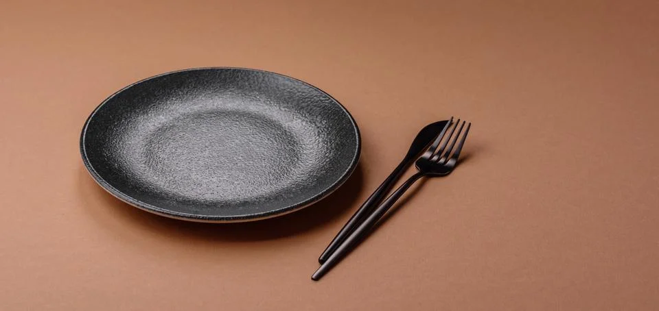 An empty round ceramic plate on a table, kitchenware. An empty plate Stock Photos