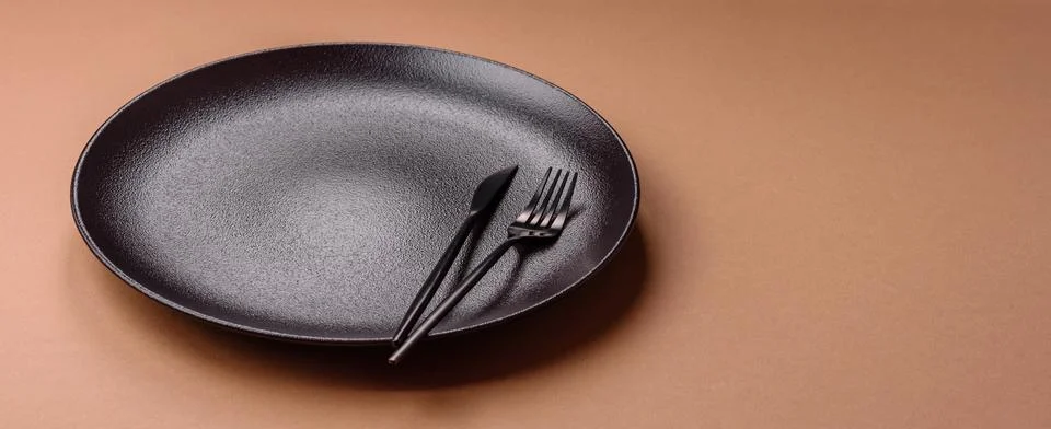 An empty round ceramic plate on a table, kitchenware. An empty plate Stock Photos
