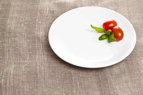 Empty round ceramic plate on tablecloth top view Fotos de archivo