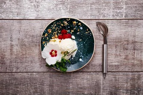 Empty round mirror on wooden table with spoon and flowers Stock Photos