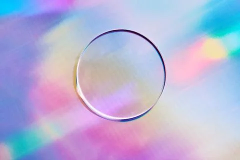 Empty round petri dish or glass slide on holographic background. Mockup for c Stock Photos