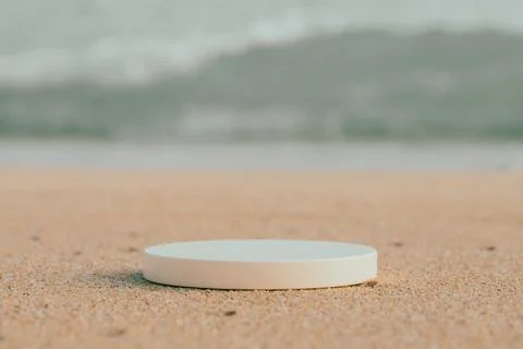 Empty round platform podium on the beach sand Stock Photos