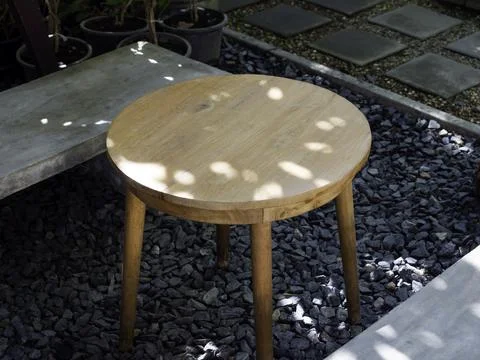 Empty round wooden side table with simple cement seat. Stock Photos