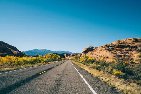 Empty route running away through rocky terrain Stock Photos