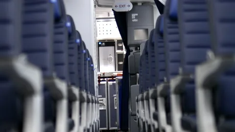 Empty row of dark blue seats inside an airplane Stock Footage 145581062