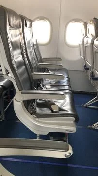 Empty row of economy class seats on an airplane Stock Photos