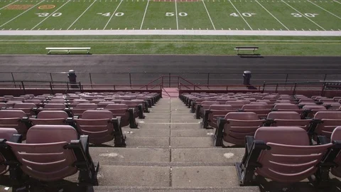 Empty rows of chairs in a high school football stadium Stock-Footage 77082071