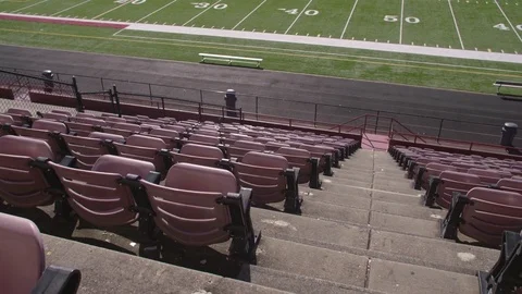Empty rows of chairs in a high school football stadium 스톡 동영상 77082350