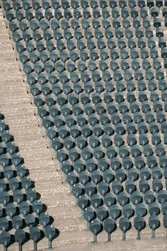 Empty rows of new comfortable plastic chairs attached to floor in an empty Фото